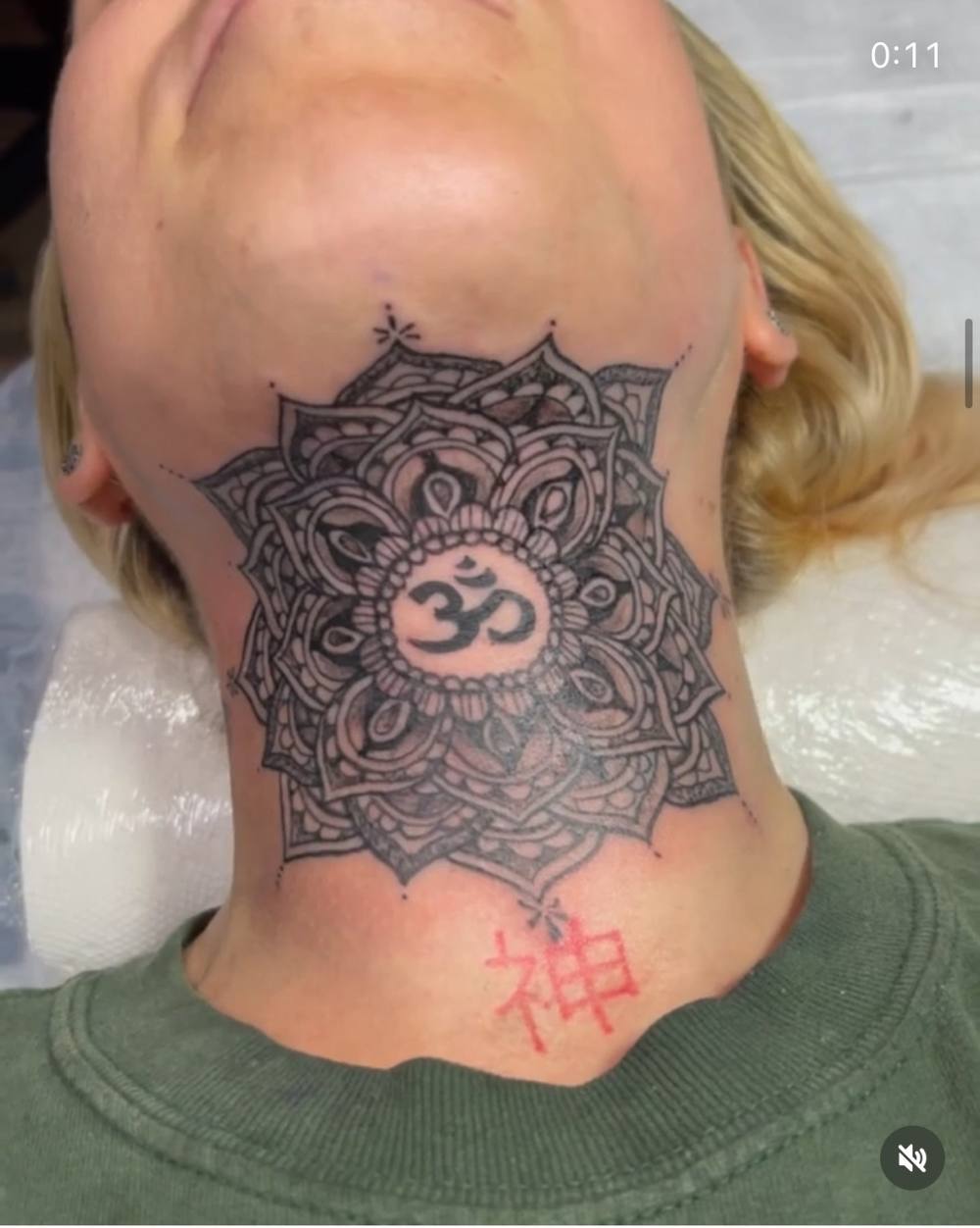 Mandala throat tattoo with Om symbol by Marcelo Tattoos Bronx