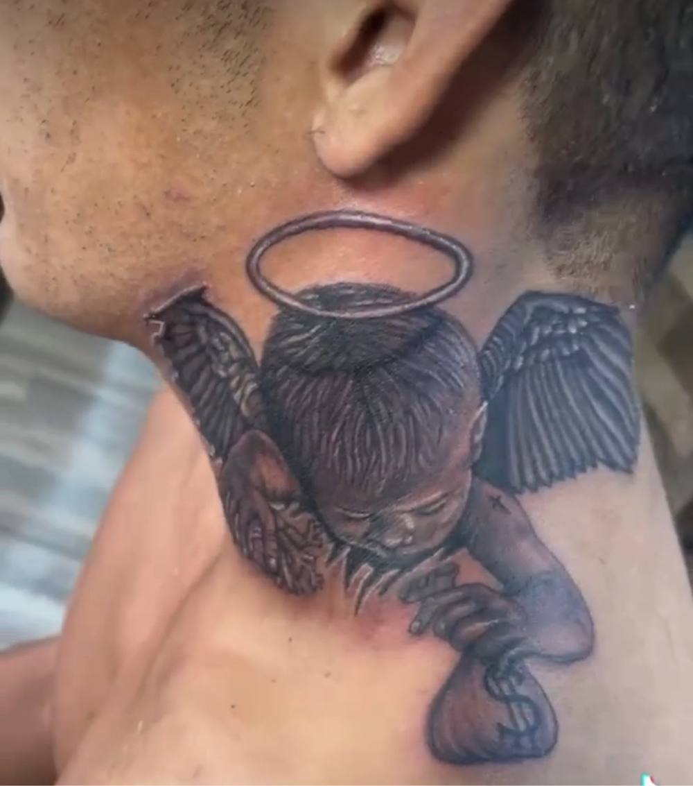 Angel baby neck tattoo by Marcelo Tattoos Bronx NY
