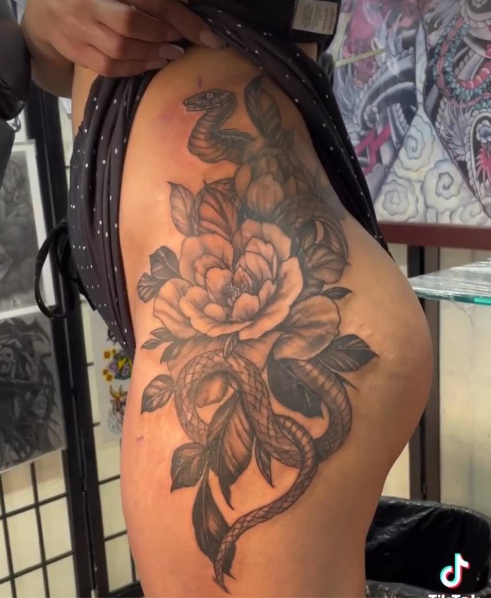 Snake and peony thigh tattoo by Marcelo Tattoos Bronx