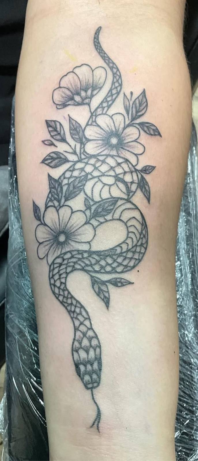 Snake and floral arm tattoo by Marcelo Tattoos Bronx NY