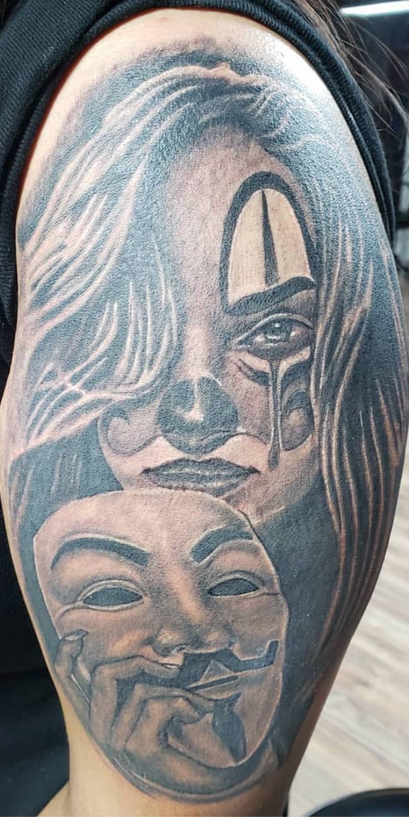 Crying woman with mask arm tattoo by Marcelo Tattoos Bronx NY
